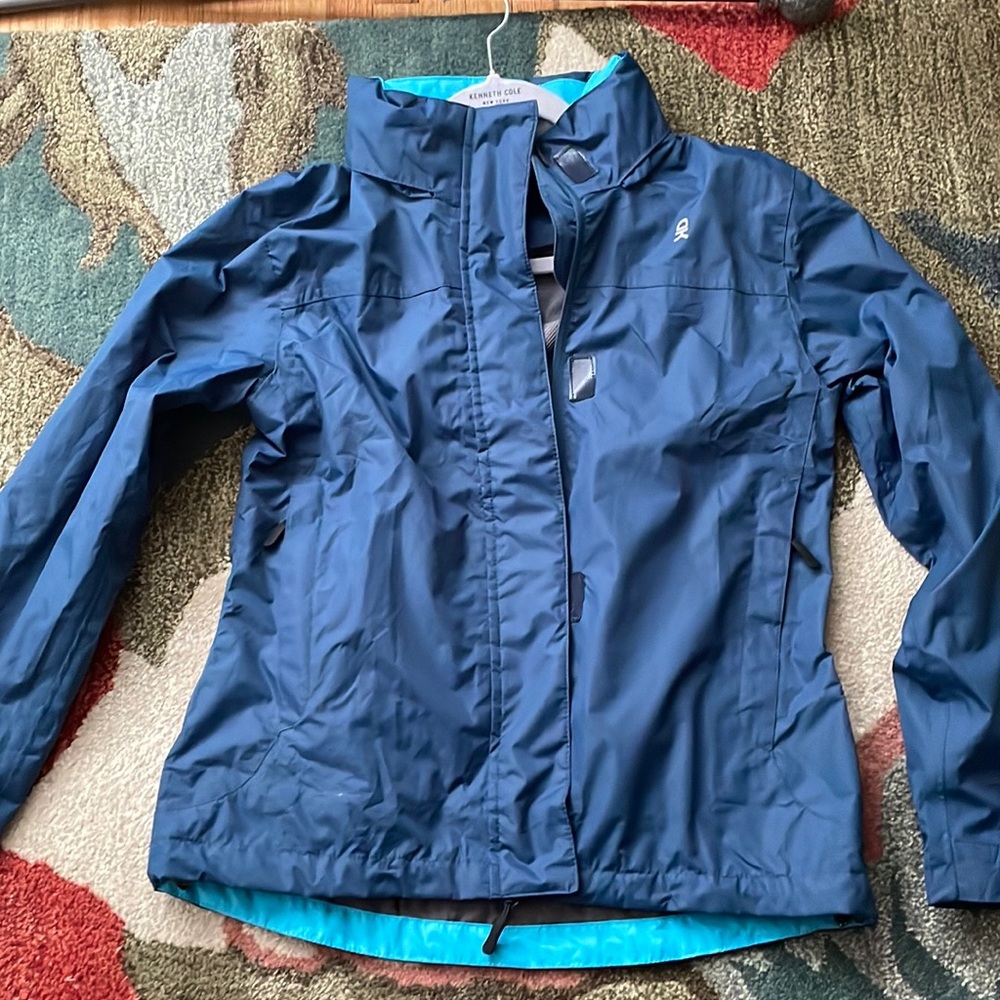 Rain /hiking jacket , water proof with tuck in hood in the back, never worn